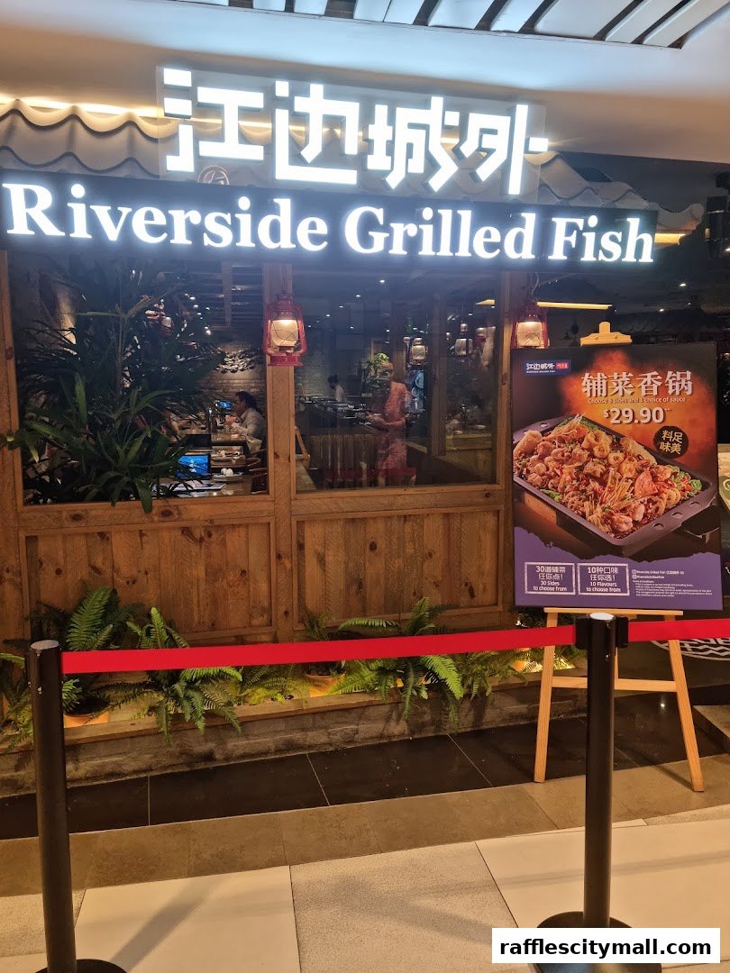 The entrance of Riverside Grilled Fish restaurant with a promotional poster.