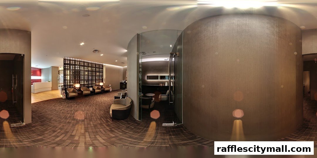 The interior of a modern spa waiting area with comfortable seating and a reception desk.