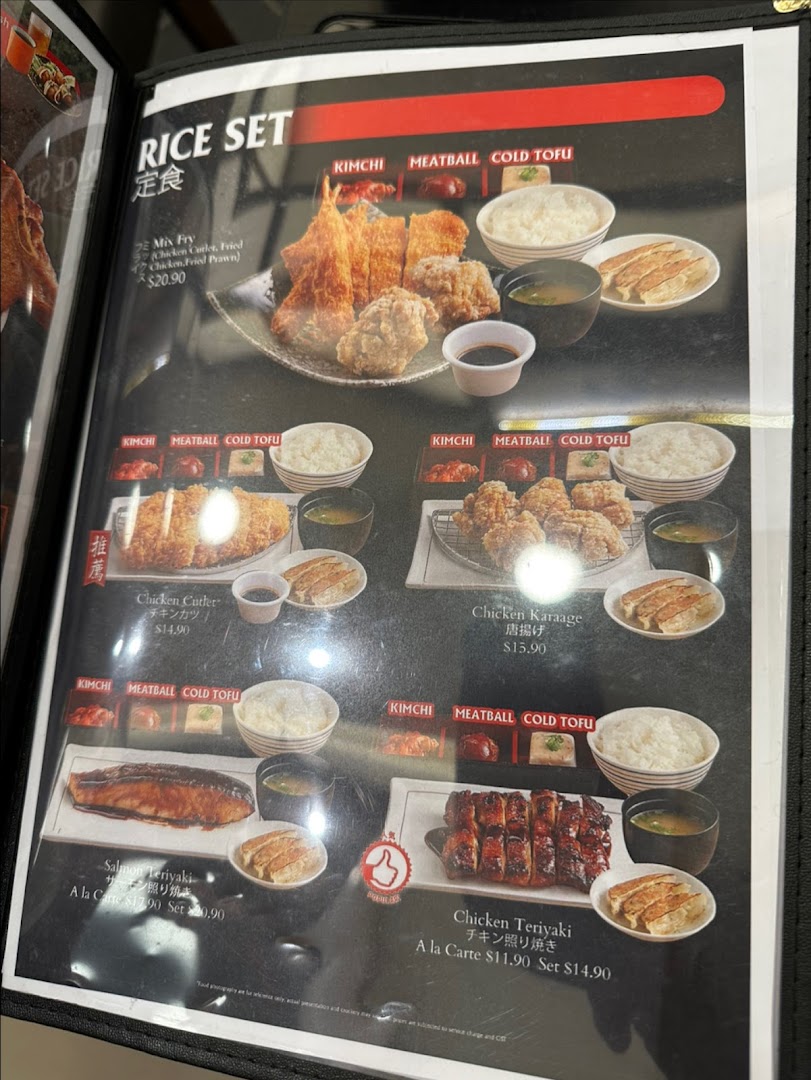 A detailed menu page showcasing various Japanese rice sets with fried chicken, salmon, and teriyaki options.
