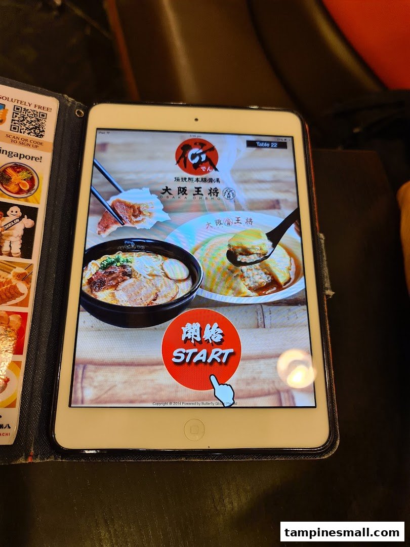 An iPad displaying the digital ordering interface for Osaka Ohsho, featuring ramen and other dishes.