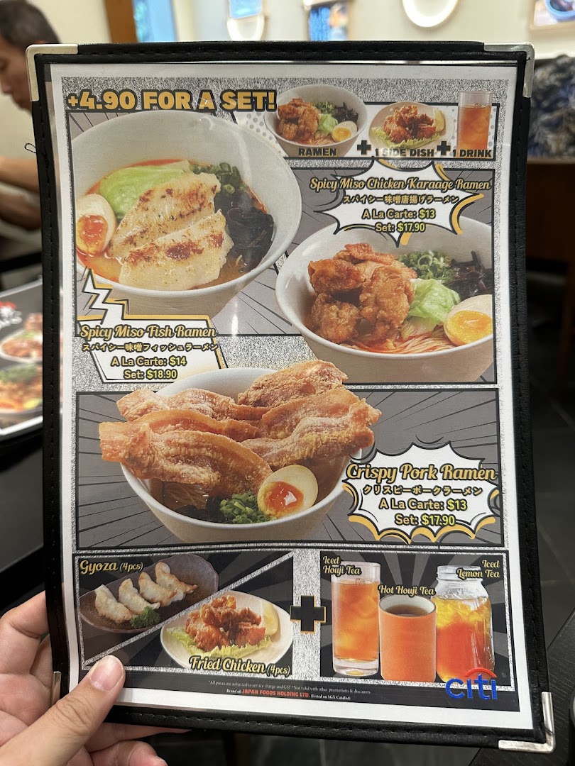 A close-up of a ramen restaurant's menu displaying various ramen dishes, side options, and drinks.