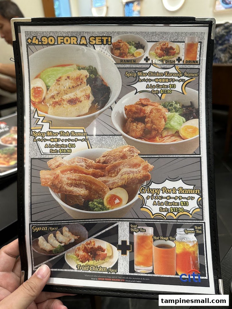 A close-up of a ramen restaurant's menu displaying various ramen dishes, side options, and drinks.