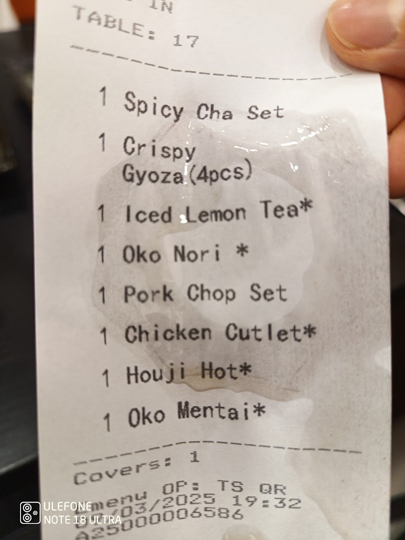 A close-up of a restaurant order slip listing various food and drink items.