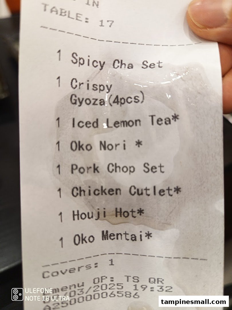 A close-up of a restaurant order slip listing various food and drink items.