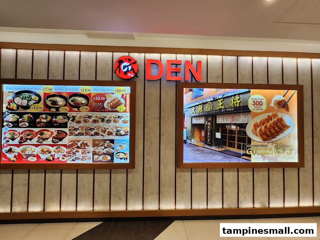 The shopfront of a Japanese eatery, featuring illuminated ramen and gyoza display boards.
