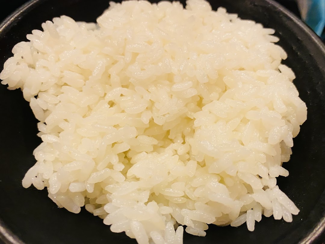 A close-up view of a bowl of perfectly steamed white rice.
