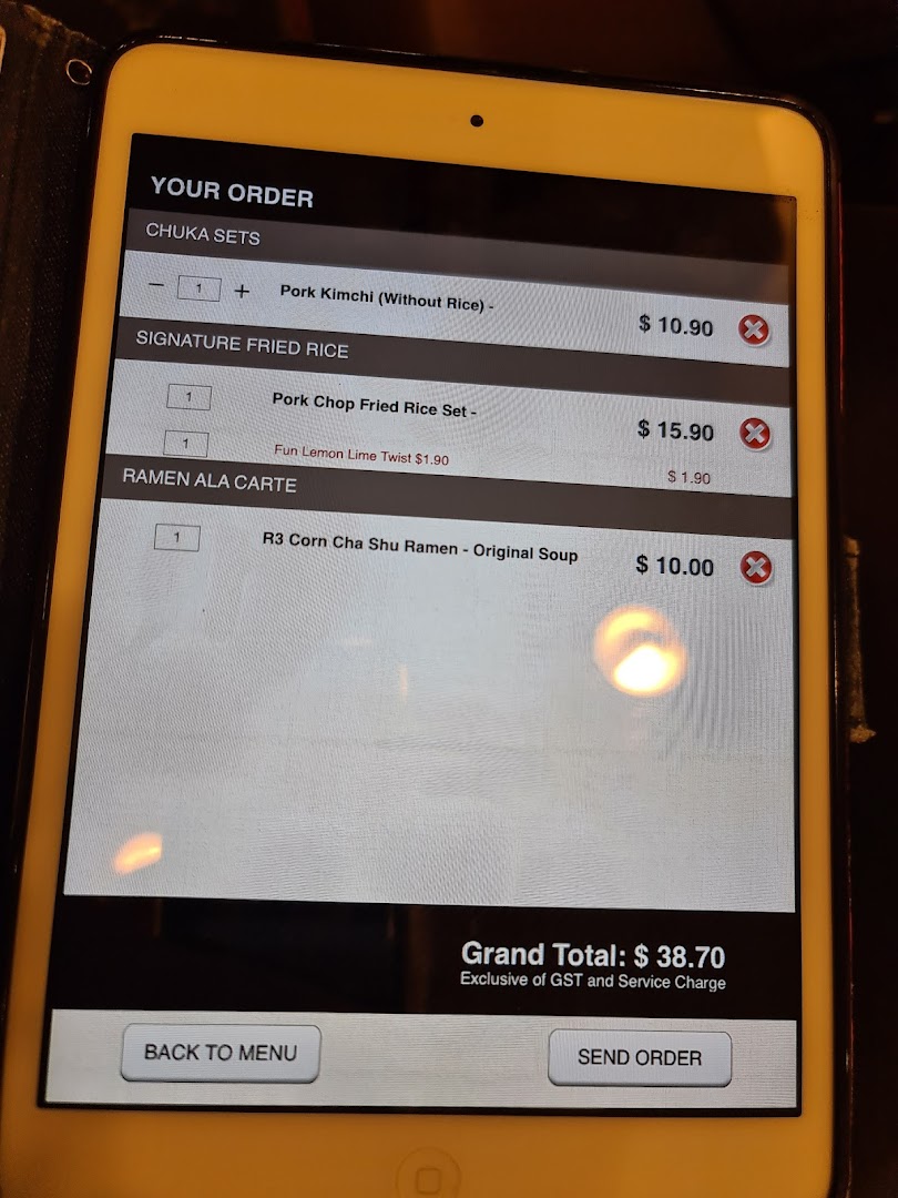 A digital order screen on a tablet displaying menu items and a grand total.