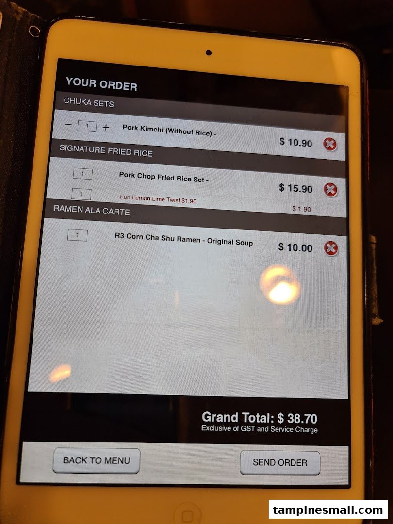 A digital order screen on a tablet displaying menu items and a grand total.