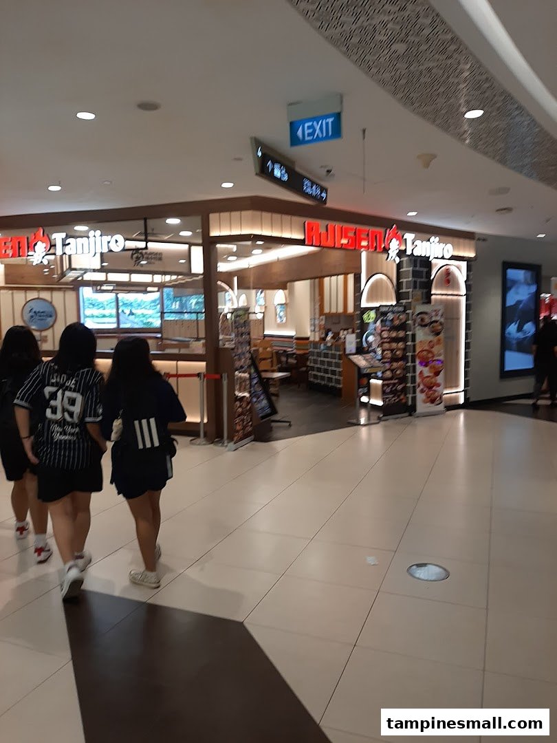 The inviting entrance of Ajisen Tanjiro restaurant, showcasing its warm interior and mall setting.