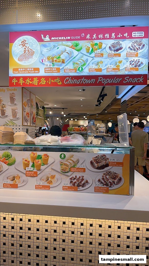A vibrant menu board and counter display showcasing Ann Chin Popiah's Michelin-recommended snacks.