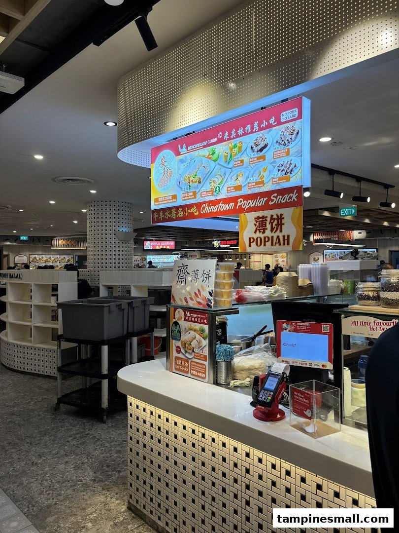 An overhead digital menu board displaying various popiah and traditional hot desserts with prices.