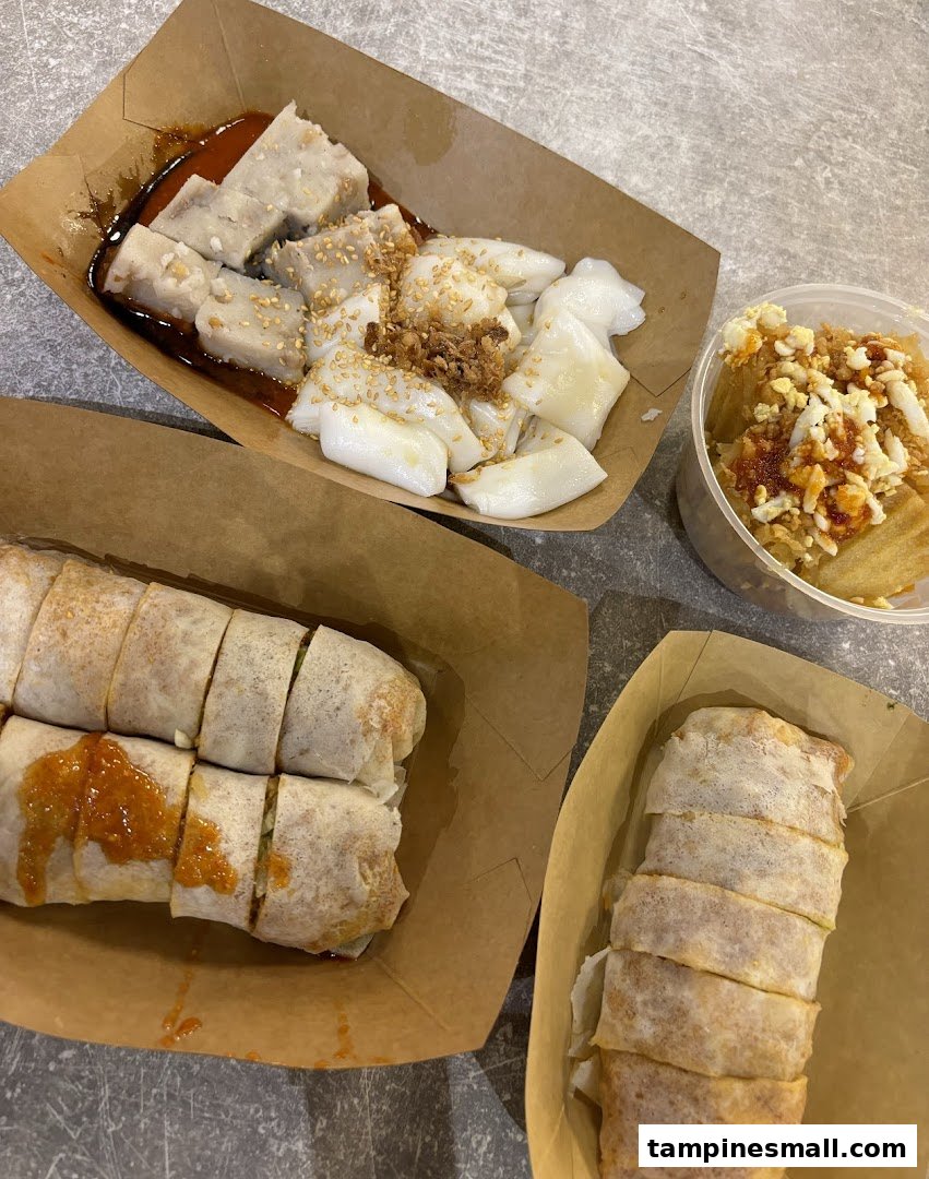 A spread of delicious Ann Chin Popiah, yam cake, and chee cheong fun in takeaway containers.