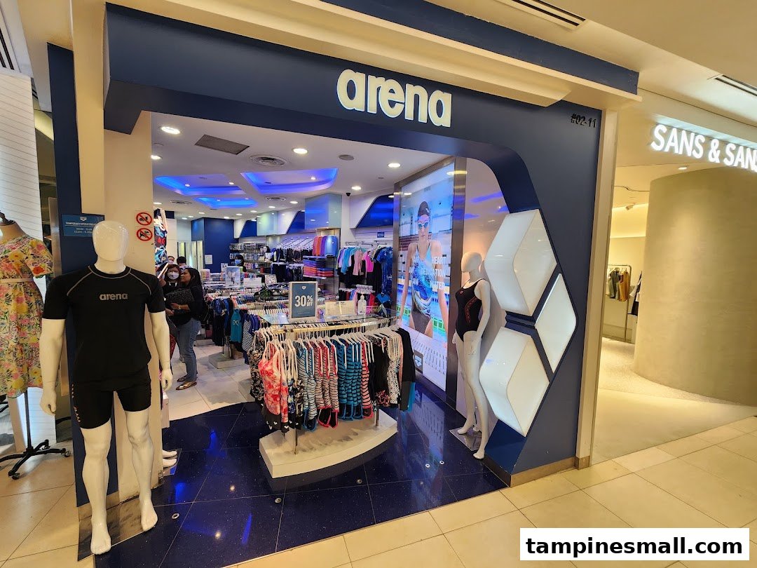 The image shows the inviting entrance of the Arena swimwear and sportswear shop, featuring mannequins and merchandise.