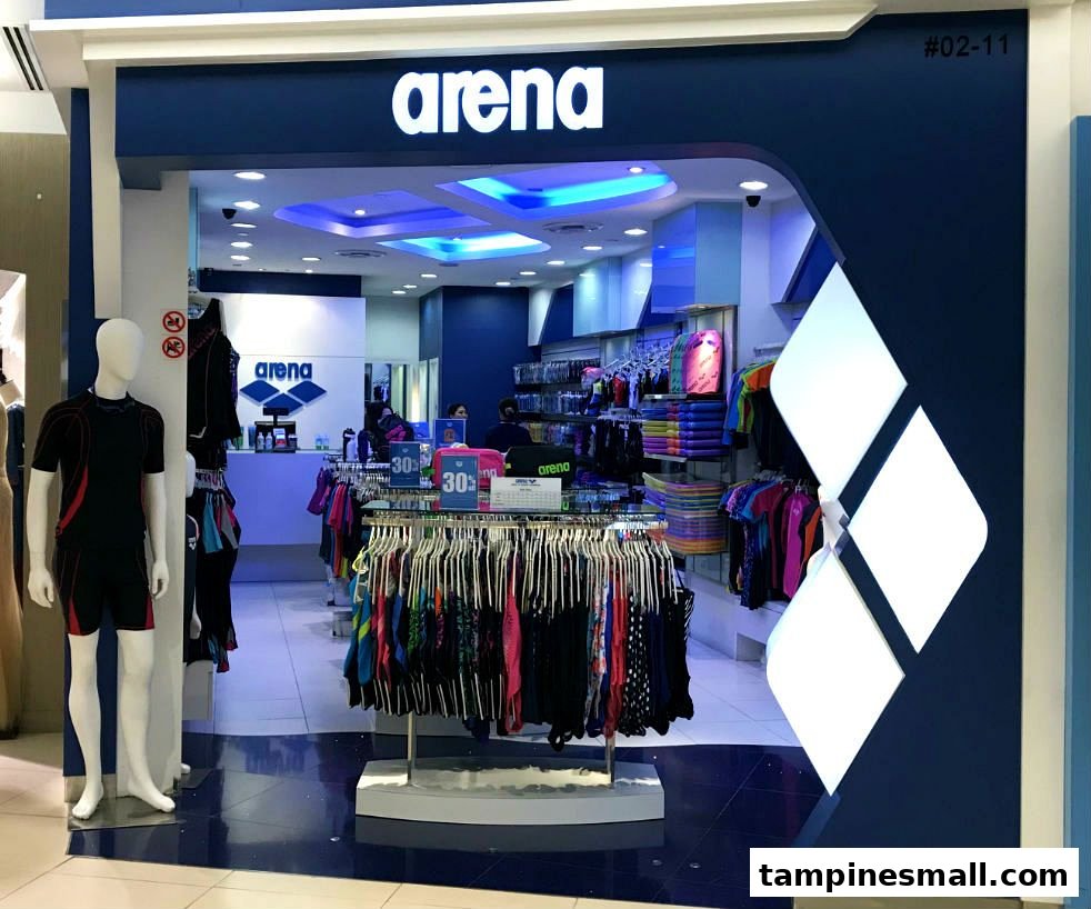 The vibrant blue storefront of 'arena', a swimwear and aquatic sports apparel shop, with a mannequin displaying merchandise.