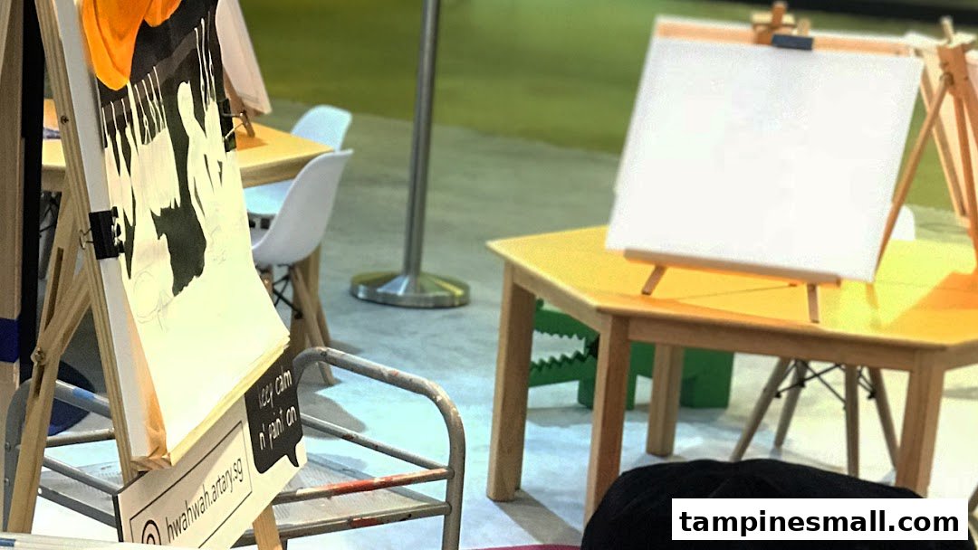 Art easels and tables set up for creative activities, featuring a partially completed artwork.