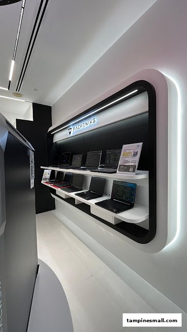 A modern display of various laptops from MACHENIKE in a retail store.