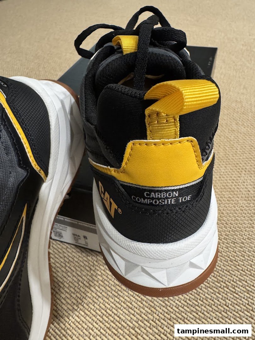 Close-up of black and yellow CAT safety shoes with carbon composite toe feature.