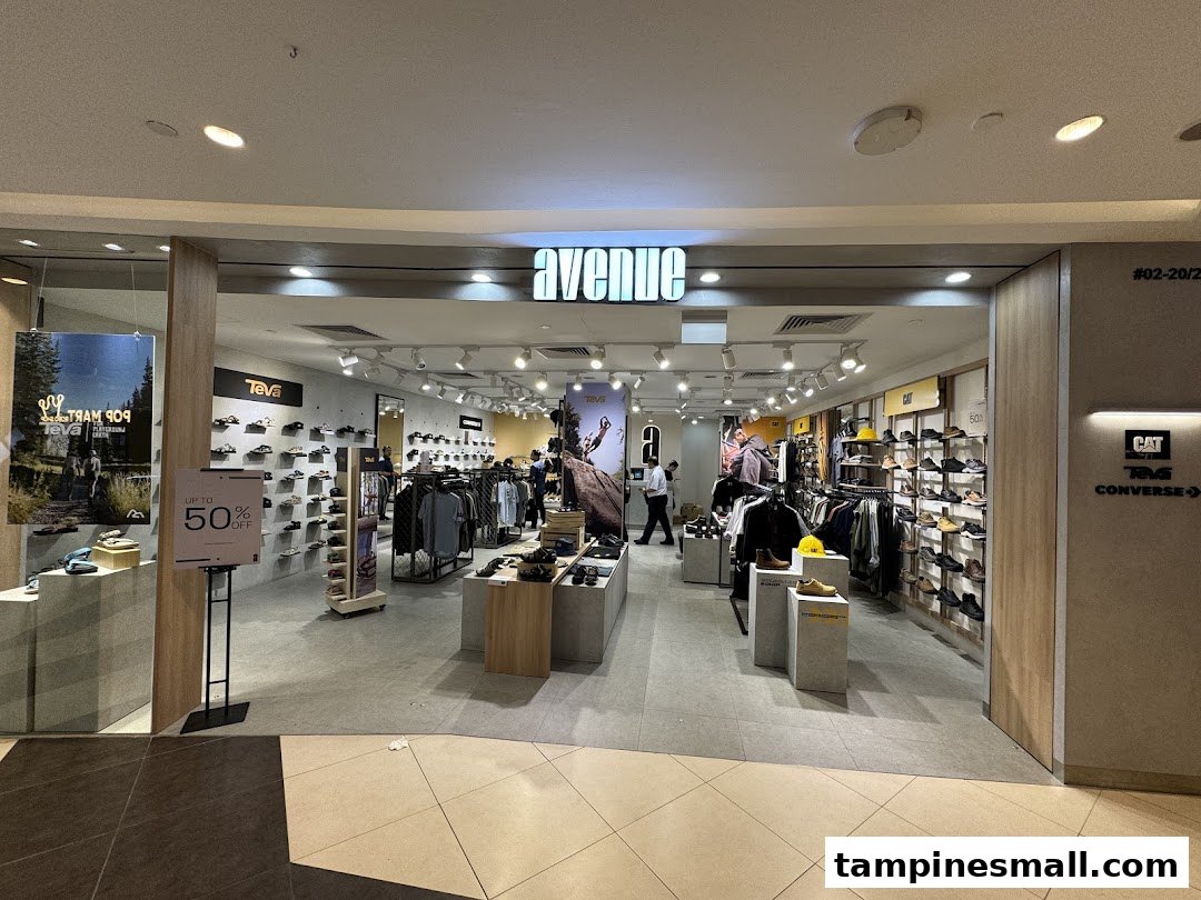 The brightly lit entrance of Avenue Tampines Mall, showcasing footwear and apparel from brands like Teva, CAT, and Converse.