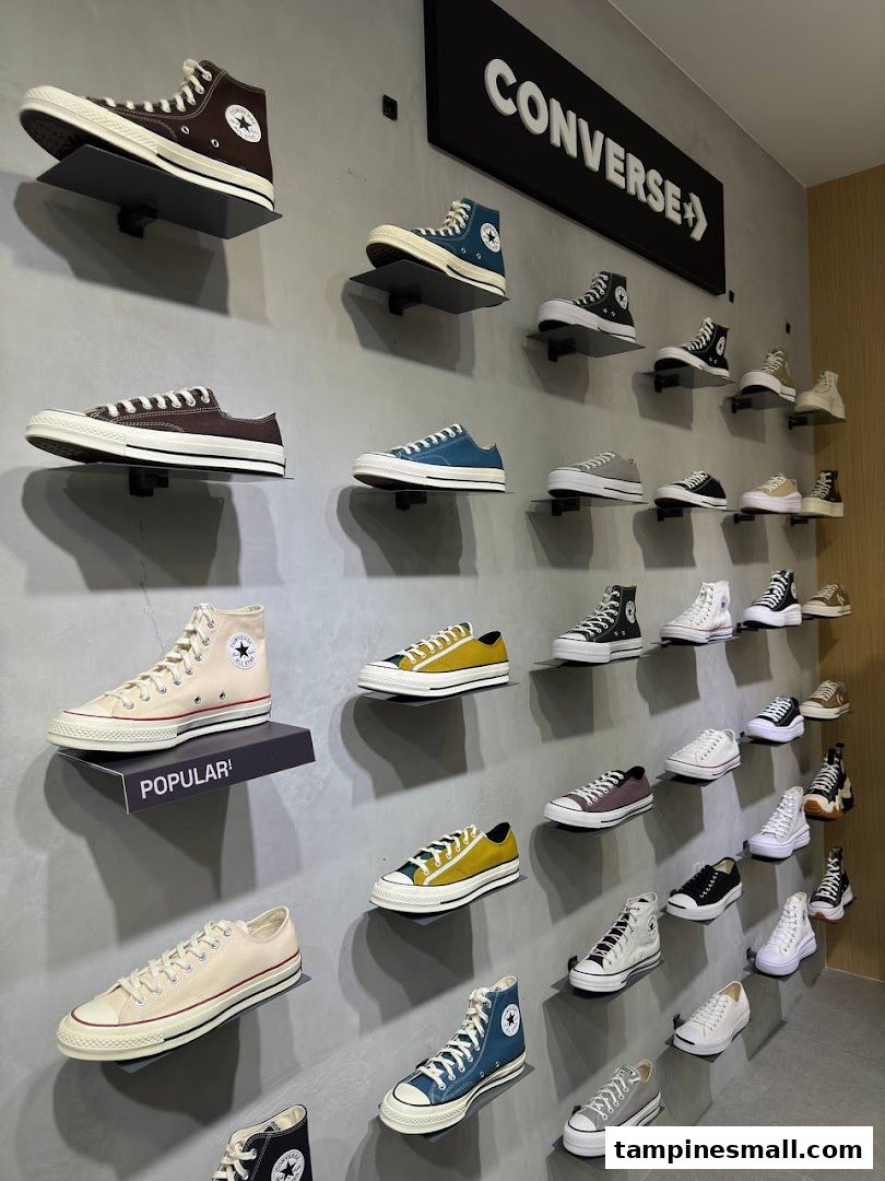 A vibrant wall display showcasing a wide variety of Converse sneakers in different colors and styles.