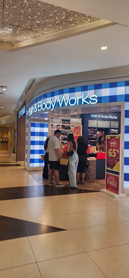 The vibrant storefront of Bath & Body Works at Tampines Mall, showcasing customers and prominent sale signage.