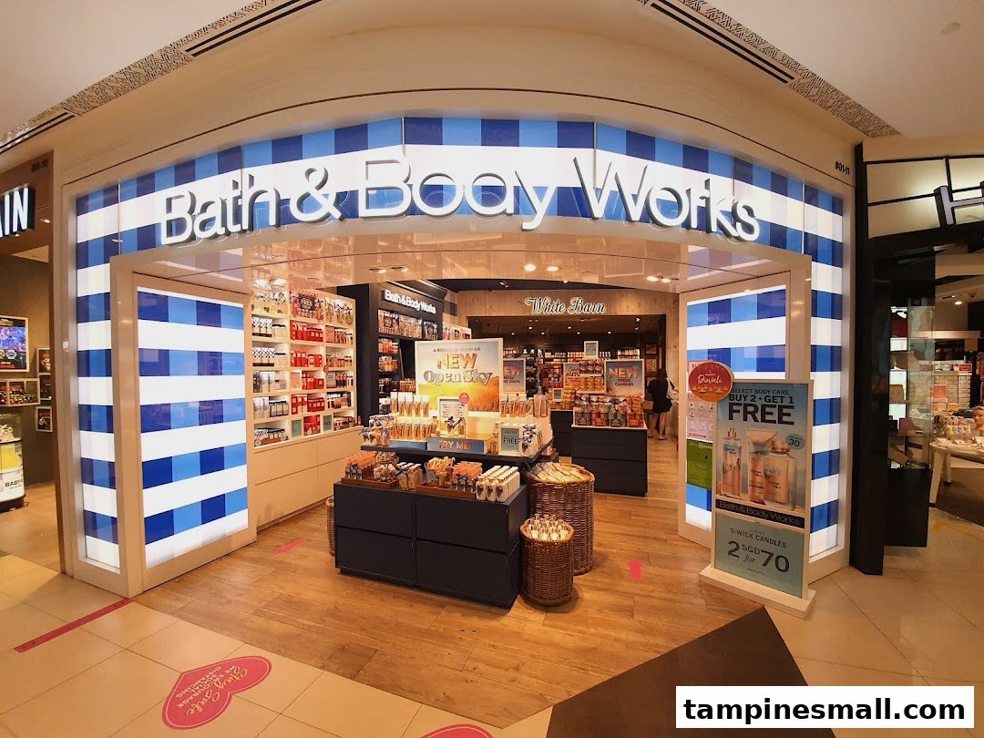 The vibrant storefront of Bath & Body Works, featuring its signature blue and white stripes and inviting product displays.