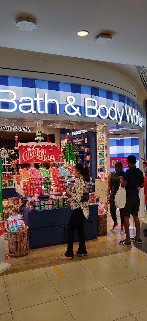 The Bath & Body Works shop entrance, featuring festive Christmas decorations and customers browsing products.