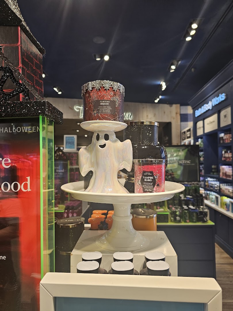 A festive Halloween display featuring 'Vampire Blood' candles and a ghost holder inside Bath & Body Works.