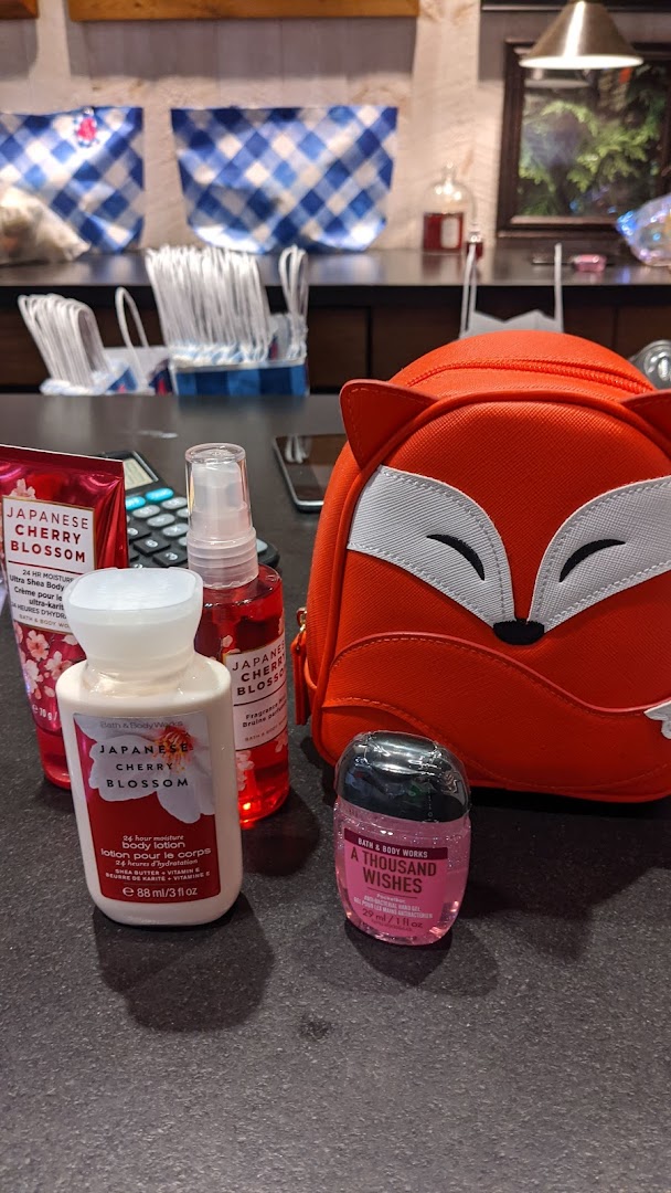 A selection of Bath & Body Works products, including Japanese Cherry Blossom lotion and mist, and a fox-themed bag.
