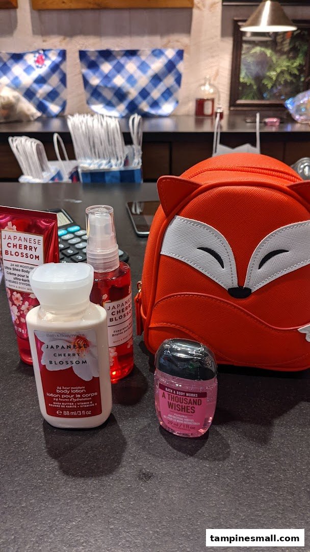 A selection of Bath & Body Works products, including Japanese Cherry Blossom lotion and mist, and a fox-themed bag.