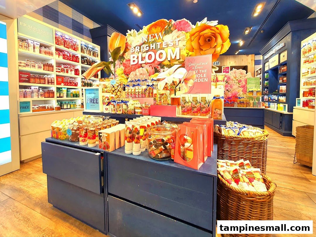 Vibrant interior of Bath & Body Works, showcasing a 'New Brightest Bloom' display with various fragranced products.