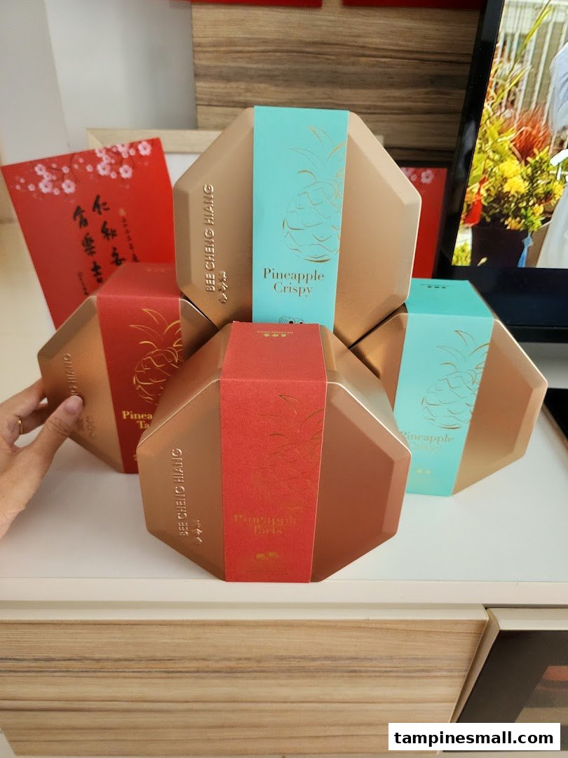 Hexagonal gift boxes of Bee Cheng Hiang Pineapple Crispy and Pineapple Tarts are displayed.
