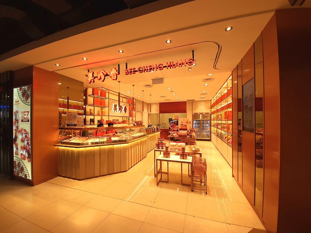 The brightly lit entrance of Bee Cheng Hiang, showcasing its inviting counter and product displays.
