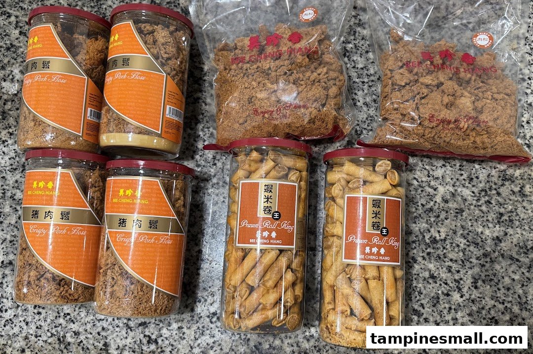 A collection of Bee Cheng Hiang products, including Crispy Pork Floss in jars and bags, and Prawn Roll King.