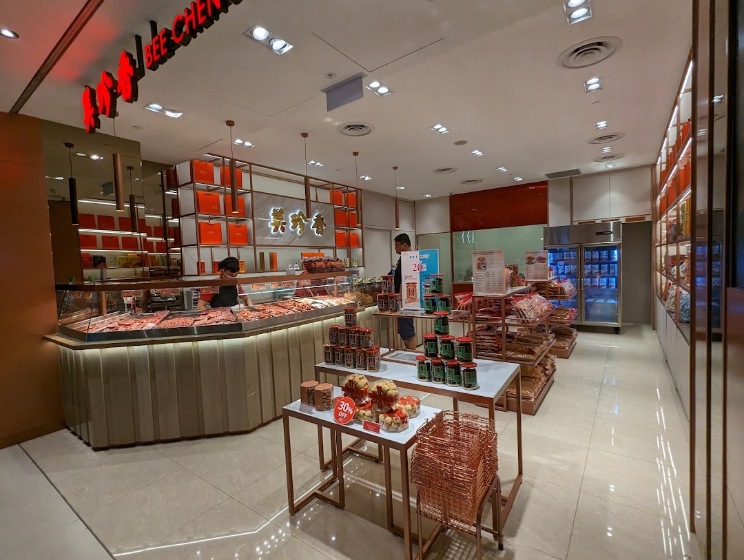 Interior view of Bee Cheng Hiang, showcasing their bak kwa display, packaged products, and staff.
