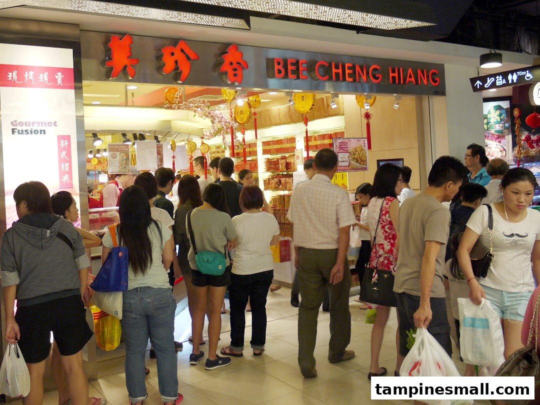 A bustling Bee Cheng Hiang shop front with customers entering and browsing traditional bak kwa products.