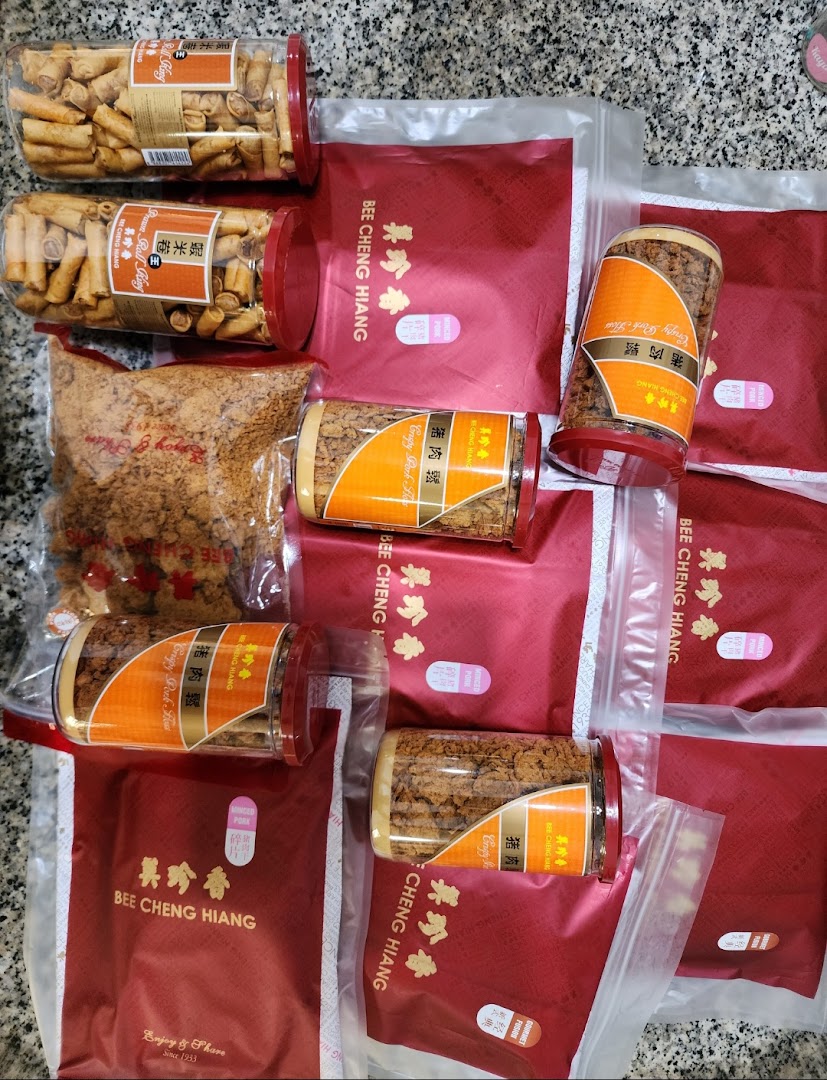 A collection of Bee Cheng Hiang products, including crispy pork floss and prawn rolls, packaged for enjoyment.