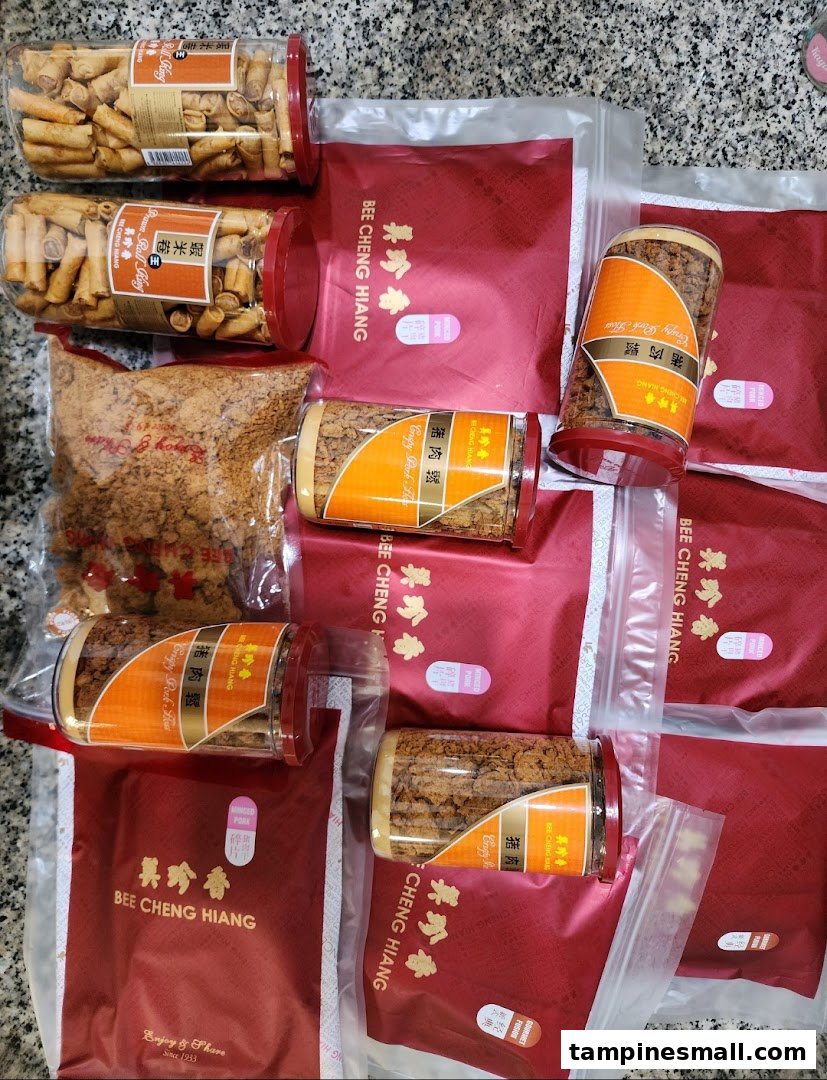 A collection of Bee Cheng Hiang products, including crispy pork floss and prawn rolls, packaged for enjoyment.