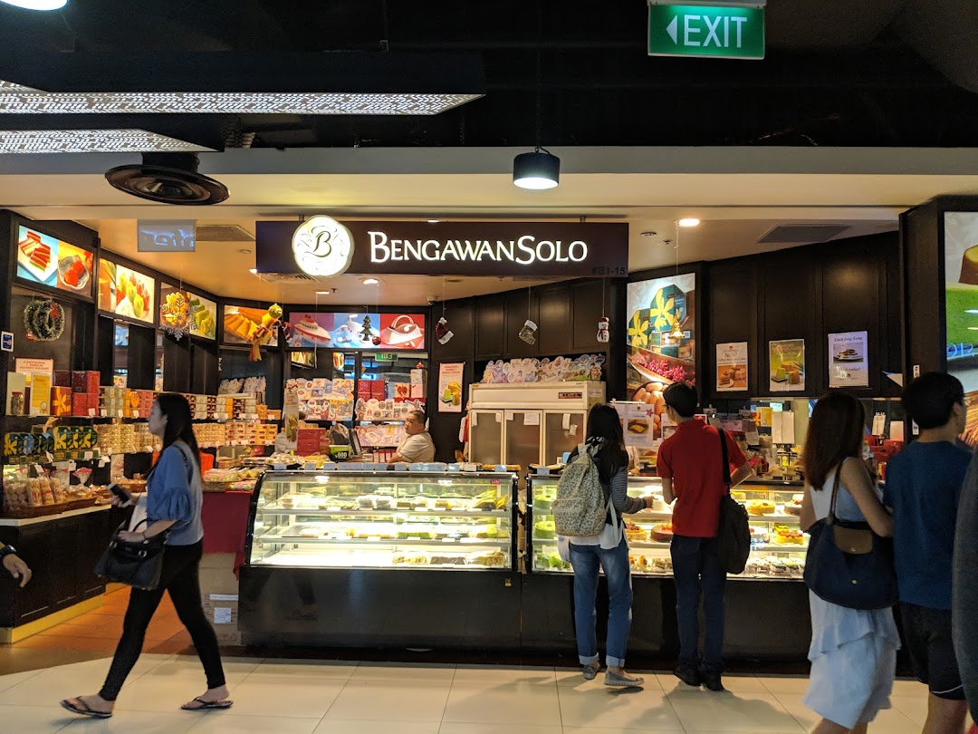 The shop front of Bengawan Solo, a bakery and cake shop, with customers browsing display cases.