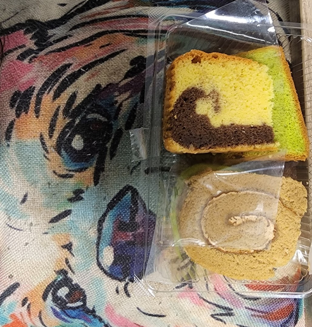Close-up of packaged Bengawan Solo cakes, including marble cake and a roll cake.