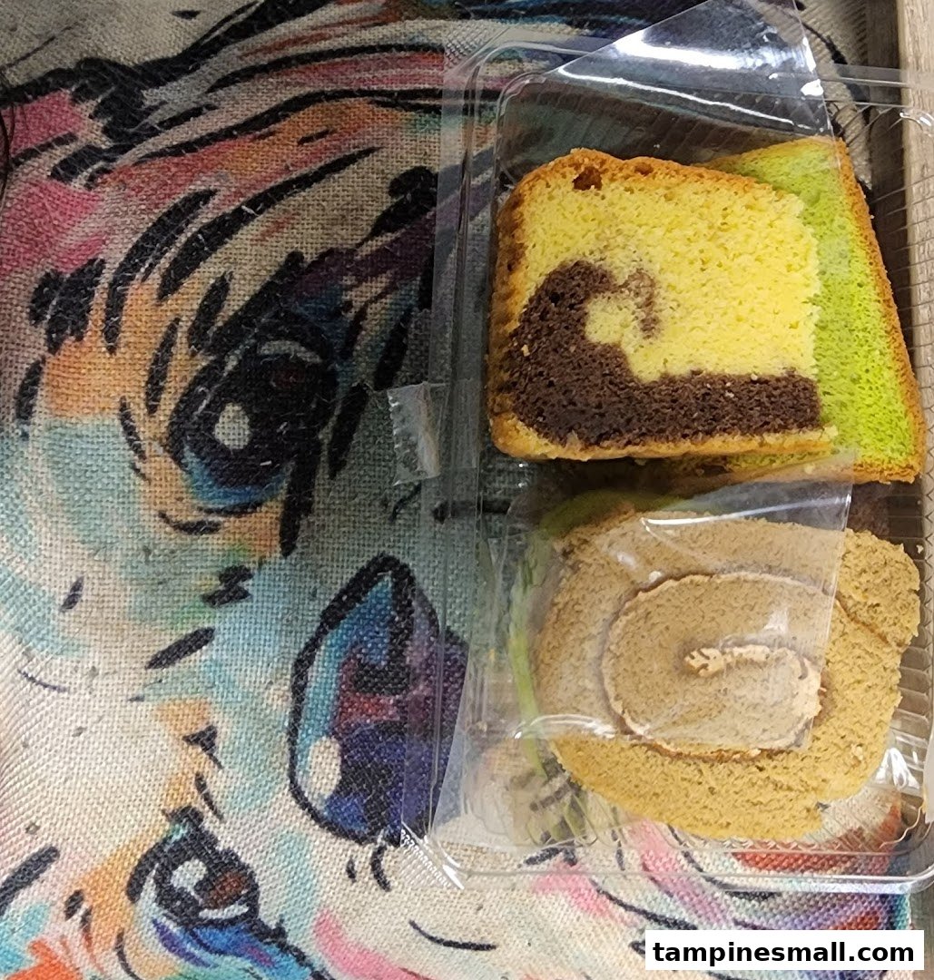 Close-up of packaged Bengawan Solo cakes, including marble cake and a roll cake.