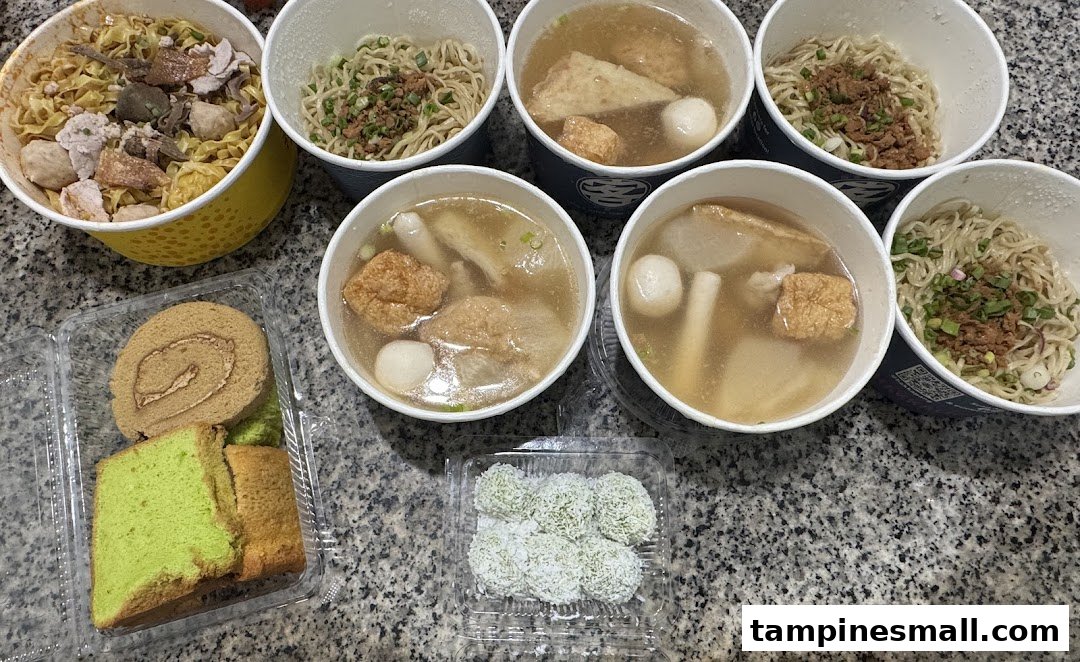 A variety of Indonesian noodles, soups, and traditional cakes from Bengawan Solo in takeaway containers.