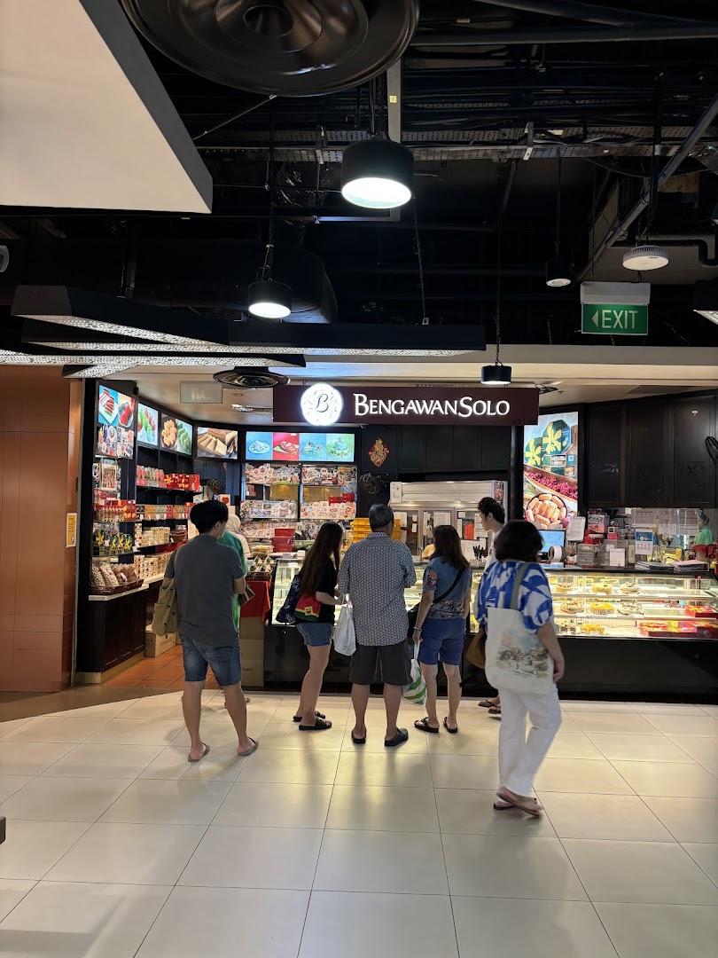 Customers browse traditional Indonesian cakes and snacks at the inviting Bengawan Solo shop front.