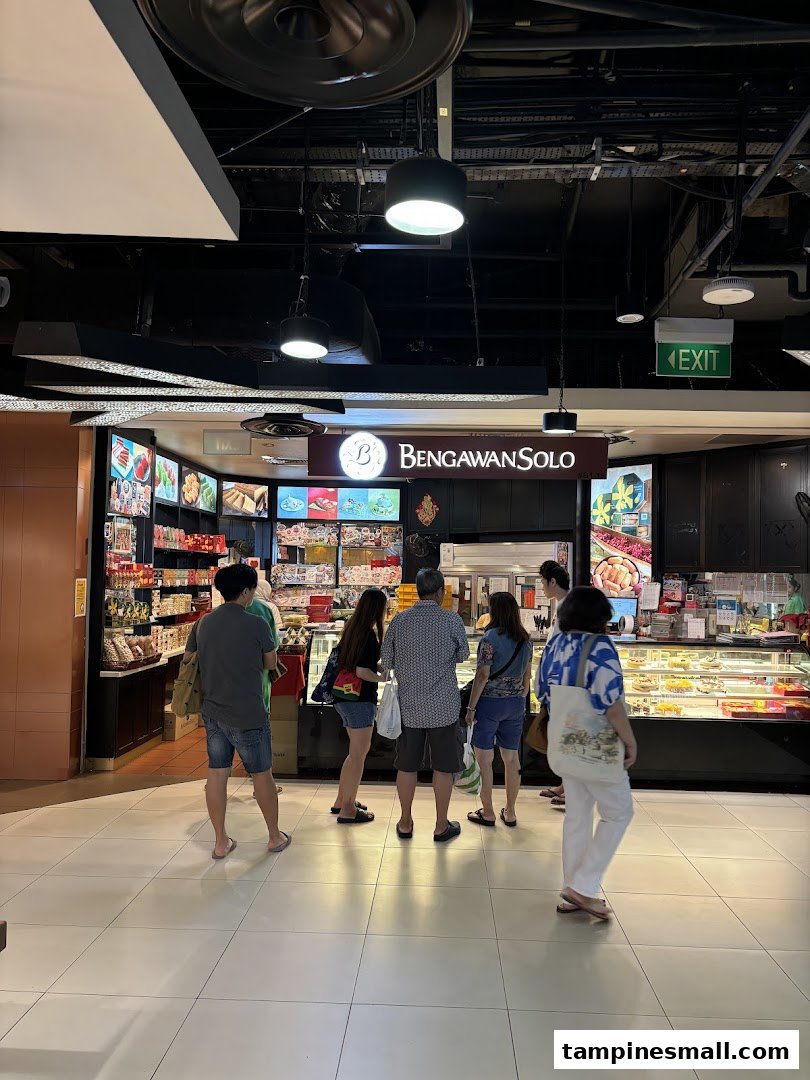 Customers browse traditional Indonesian cakes and snacks at the inviting Bengawan Solo shop front.
