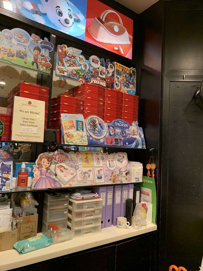 A retail counter at Bengawan Solo featuring character merchandise, red product boxes, and a hiring sign.