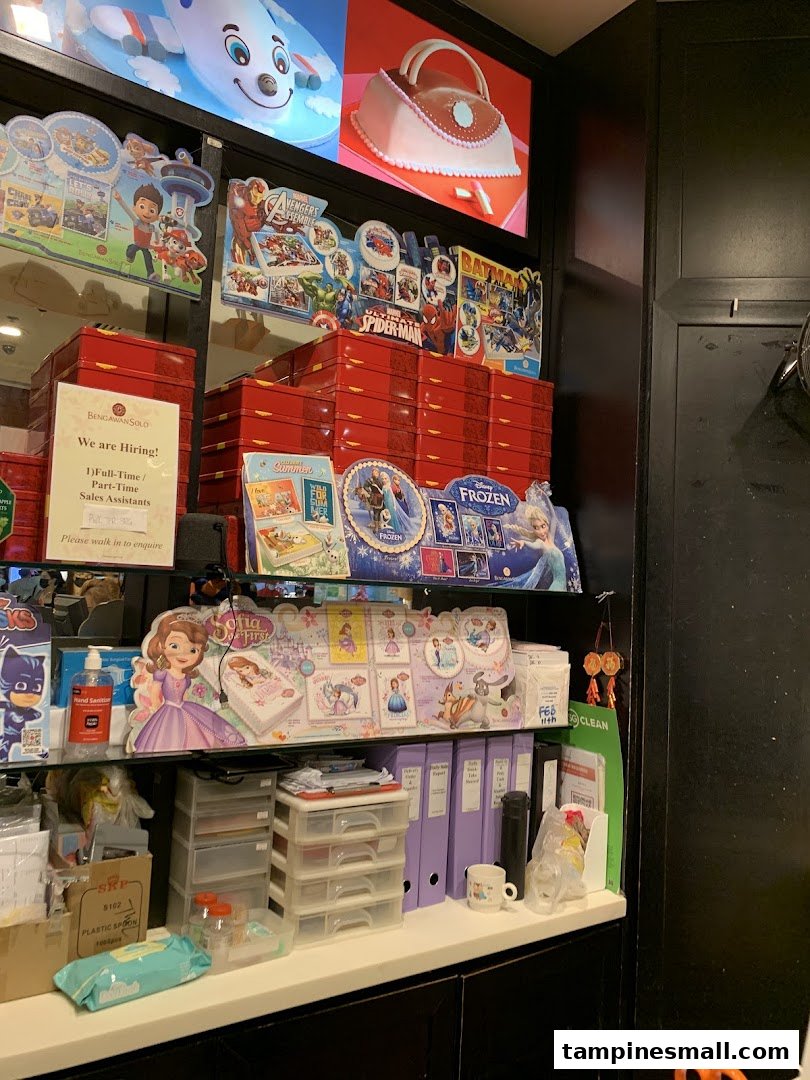 A retail counter at Bengawan Solo featuring character merchandise, red product boxes, and a hiring sign.