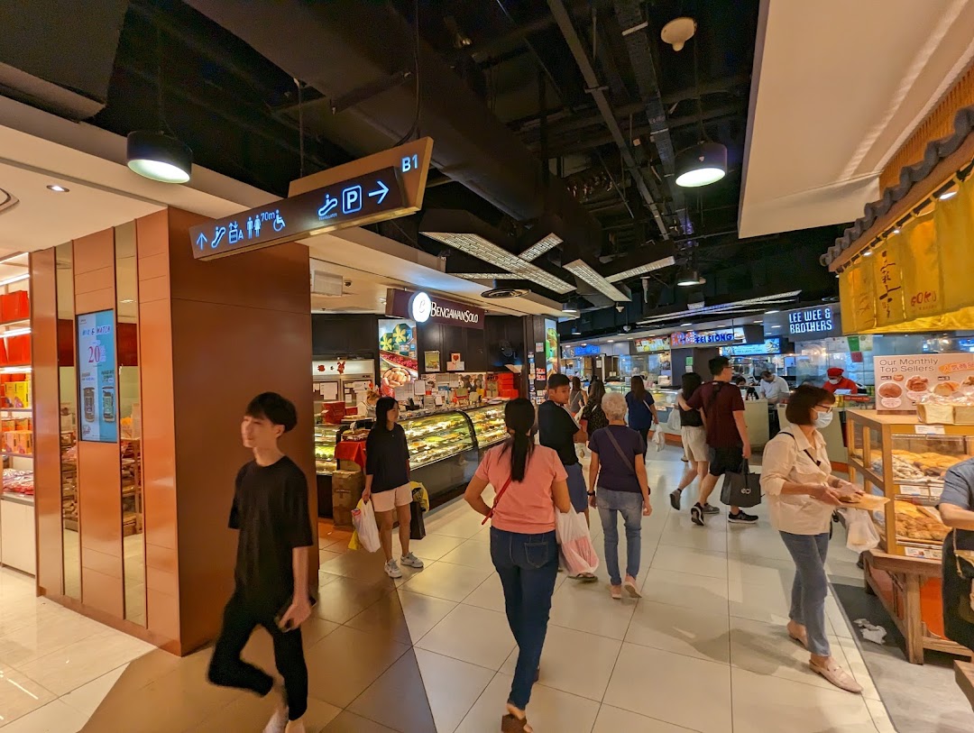 View of Bengawan Solo bakery entrance in a bustling mall corridor with shoppers.