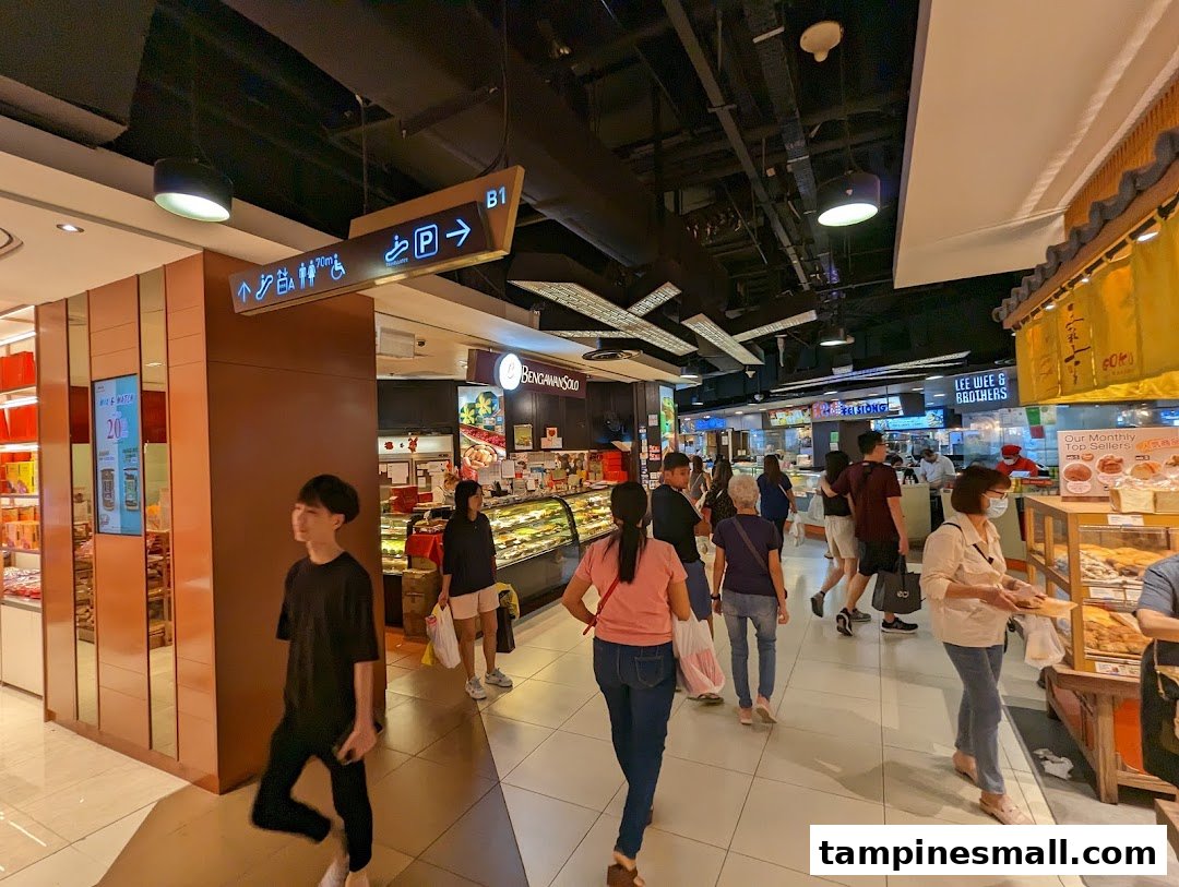 View of Bengawan Solo bakery entrance in a bustling mall corridor with shoppers.