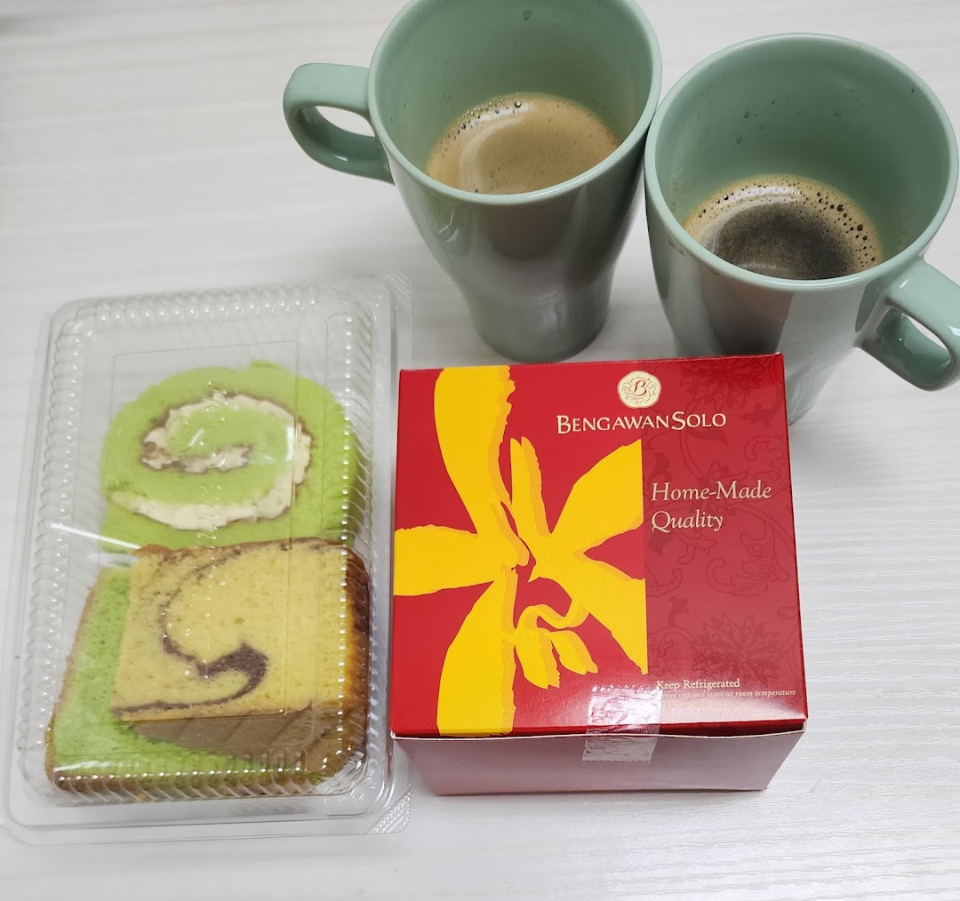 Delicious cakes from Bengawan Solo, including a pandan roll and marble cake, paired with coffee.