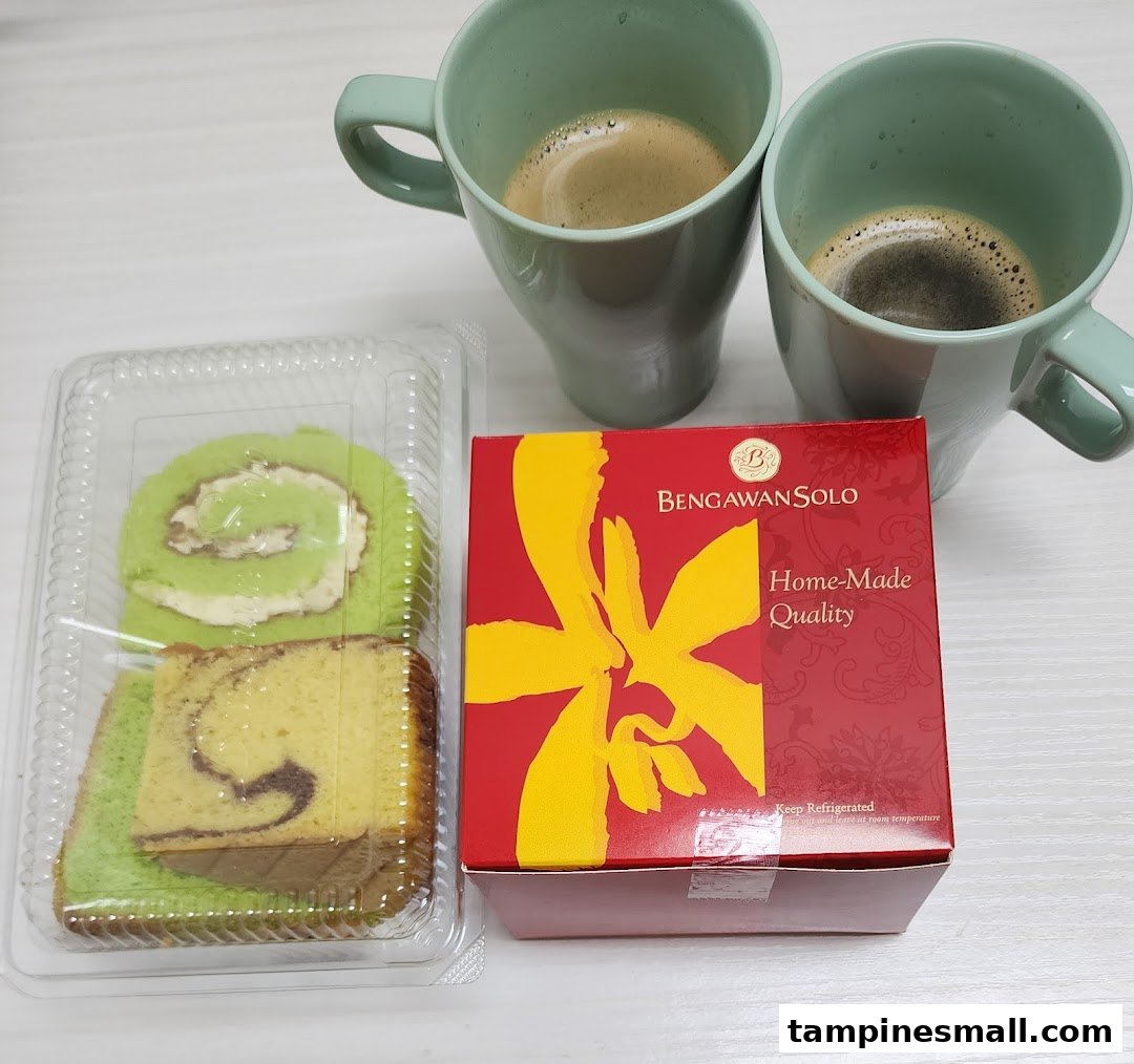 Delicious cakes from Bengawan Solo, including a pandan roll and marble cake, paired with coffee.