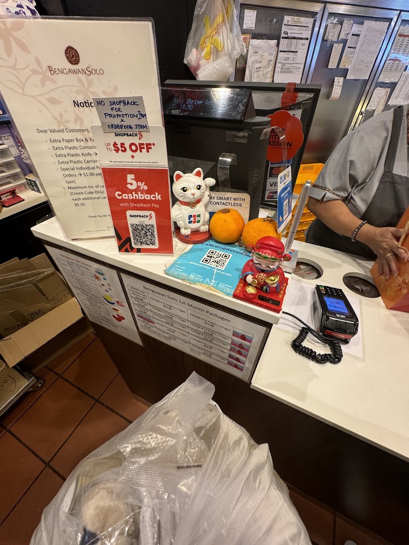 A busy checkout counter at Bengawan Solo, featuring payment options and promotional offers.